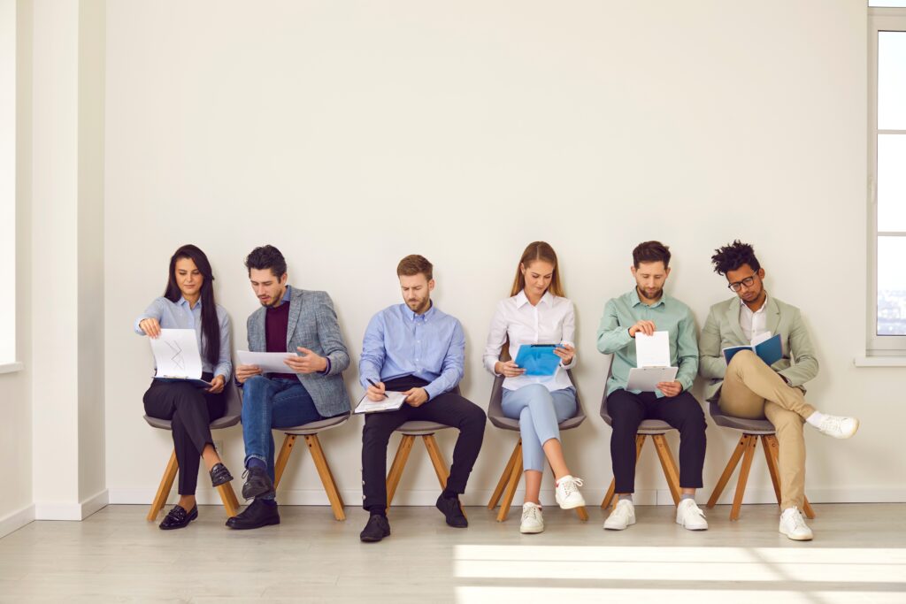 Job candidates sitting in a row waiting for interviews