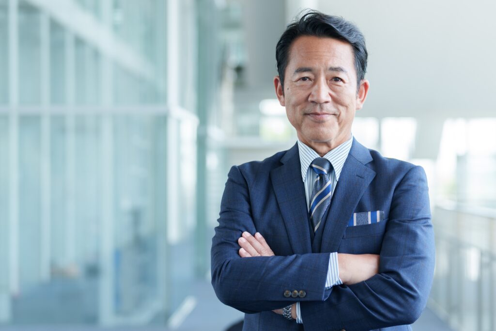 Business executive standing with arms crossed