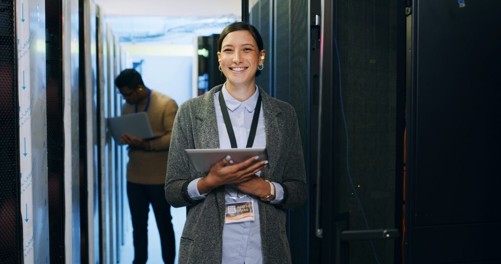 IT technician holding a tablet in a server room